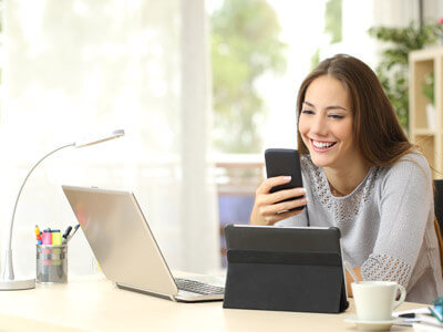 Woman Smiling at Smartphone